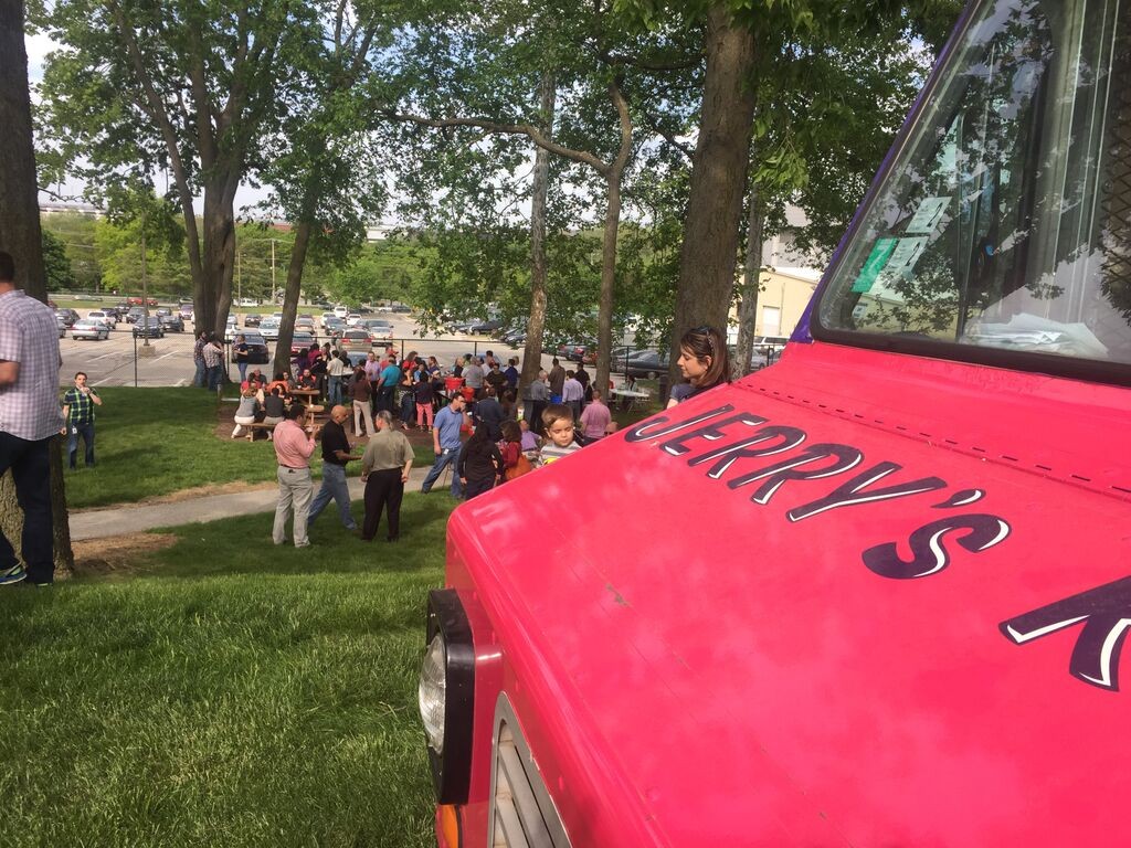A sleek truck providing corporate food truck catering services in a business park parking lot.